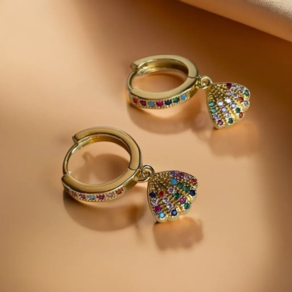 Shimmering 18K gold-plated rainbow shell earrings. Lightweight, radiant, and inspired by the magic of Parisian sunsets. A touch of French enchantment.
Rainbow crystal shell earrings in gold
Colorful lightweight earrings for women
Elegant 18K gold rainbow earrings with Parisian charm