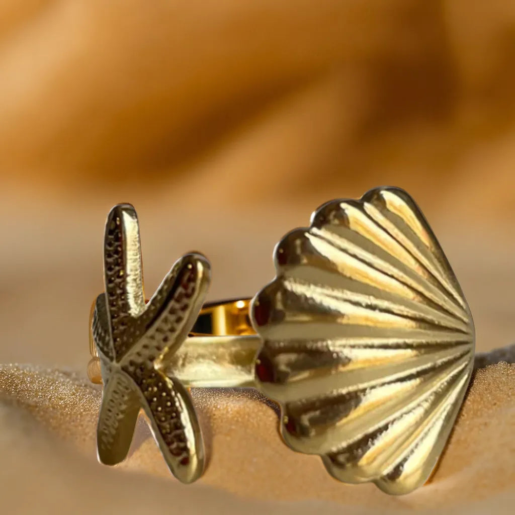 Women gold ring with starfish and shell design – front view
Gold plated ring for woman – side profile of coastal motif
Anneau Trésor Marin – adjustable gold ring with beach-inspired details
Gold ring for woman – ocean-themed jewelry on hand m