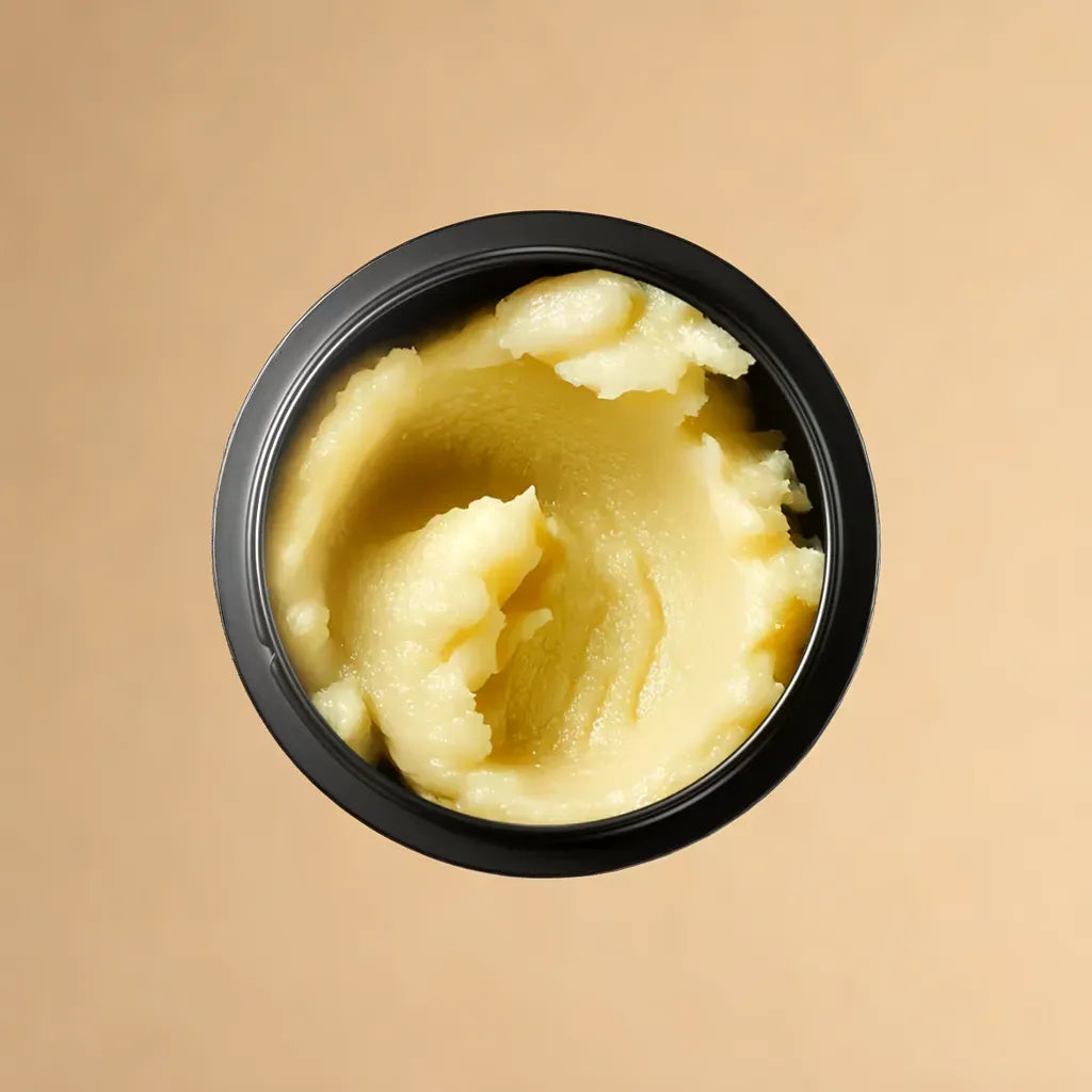 Mini whipped body butter jar – Pharaoh’s Love scent
Swatch of body butter – creamy texture
Travel-size shea body butter on neutral background
Amber and vanilla-inspired body care flat lay