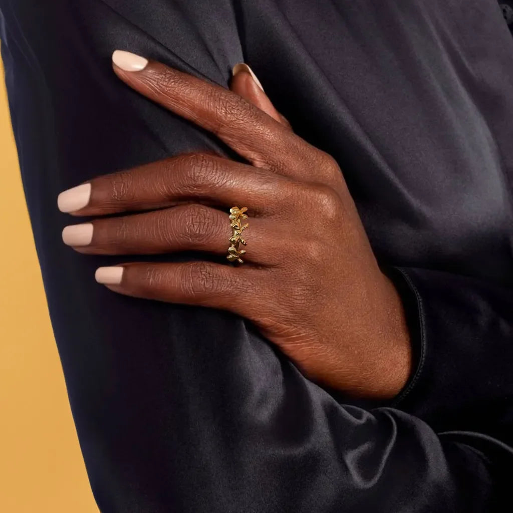 Gold bow ring with delicate triple-knot design close-up view
Adjustable bow ring shown on hand for sizing reference
Gold ring for women styled with other rings for a layered look
Elegant gold bow ring detail highlighting the 18k plating