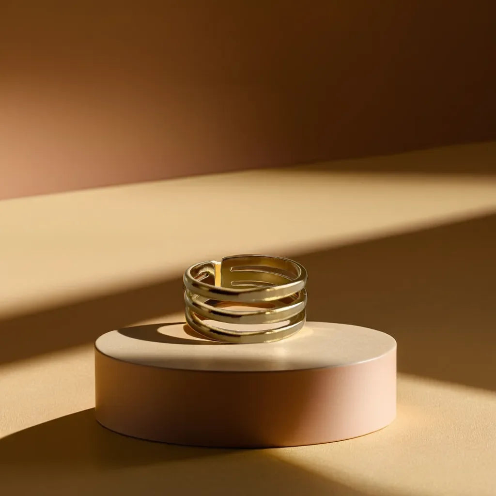 Minimalist gold band ring for women featuring triple-line design close-up
Adjustable gold ring for women with a sleek, modern aesthetic side view
Gold band ring womens style displayed on a model’s hand for scale
Elegant layering of minimalist gold ring with other rings on hand