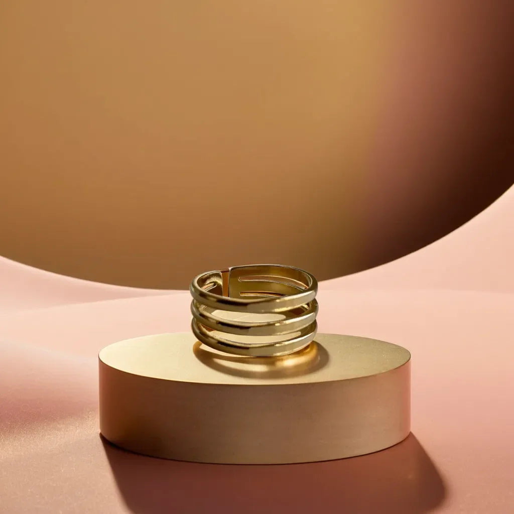 Minimalist gold band ring for women featuring triple-line design close-up
Adjustable gold ring for women with a sleek, modern aesthetic side view
Gold band ring womens style displayed on a model’s hand for scale
Elegant layering of minimalist gold ring with other rings on hand