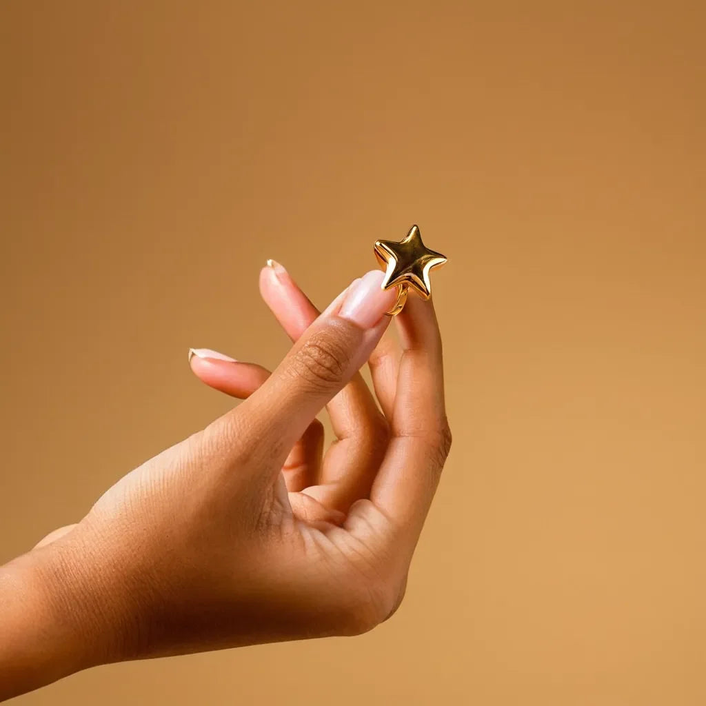 Close-up of women gold ring with chunky star design – Anneau Étoile Majestueuse
Side view showing gold band ring womens with 18k gold shine and bold star motif
Lifestyle shot of women gold ring paired with elegant evening attire
Detailed image of gold bands for women with textured star embellishment