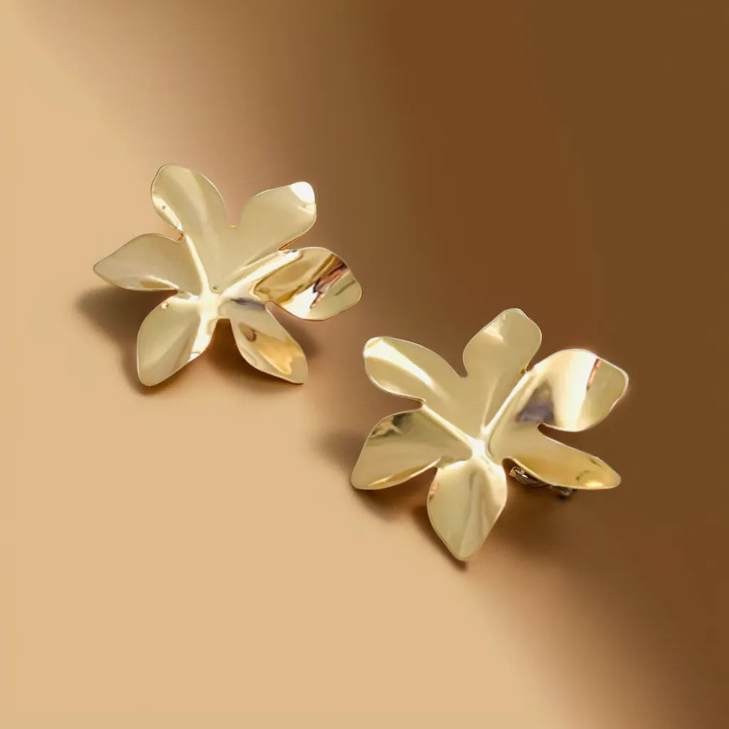 Petal-shaped gold earrings for women (37x32mm) displayed on satin background
Close-up of floral-inspired gold earrings with textured finish
Model wearing elegant women gold earrings with pulled-back hairstyle