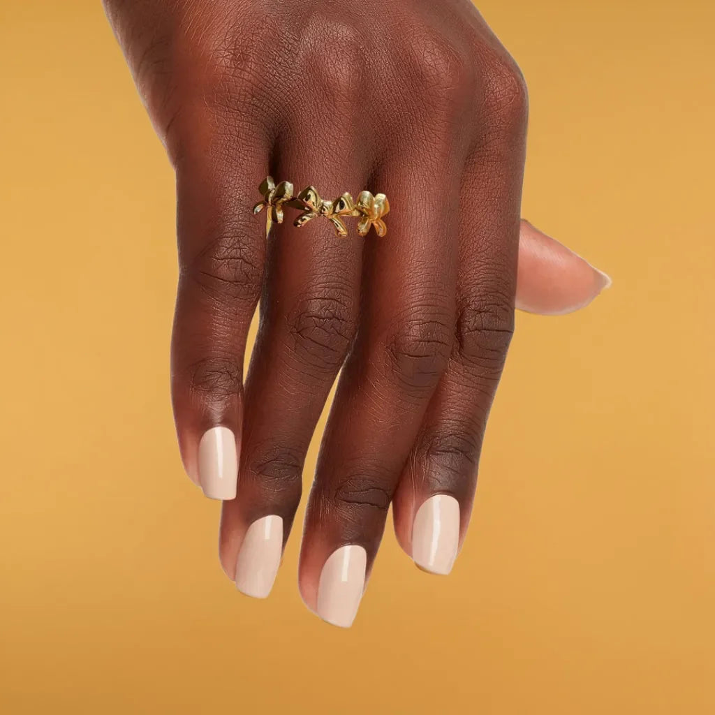 Gold bow ring with delicate triple-knot design close-up view
Adjustable bow ring shown on hand for sizing reference
Gold ring for women styled with other rings for a layered look
Elegant gold bow ring detail highlighting the 18k plating