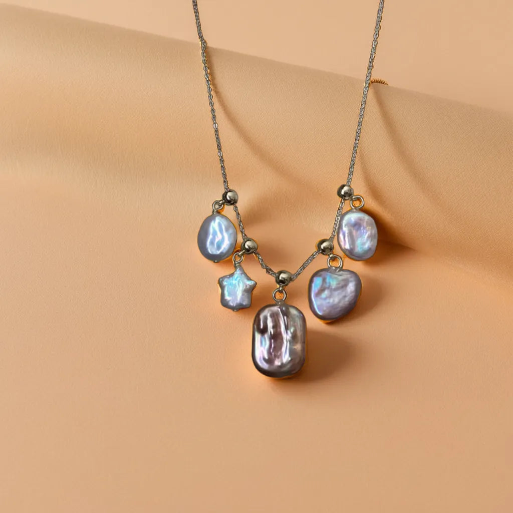 Star and pearl necklace with shimmering celestial charms
Celestial necklace styled with detachable star and heart motifs
Gold star pearl necklace with layered styling options
Star and pearl necklace showing intricate gold detailing