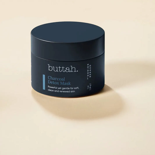 Black clay mask swatched on rich brown skin

Face with mask applied and rinsed

Product jar with charcoal and shea nuts

Skin after use—soft, smooth, radiant