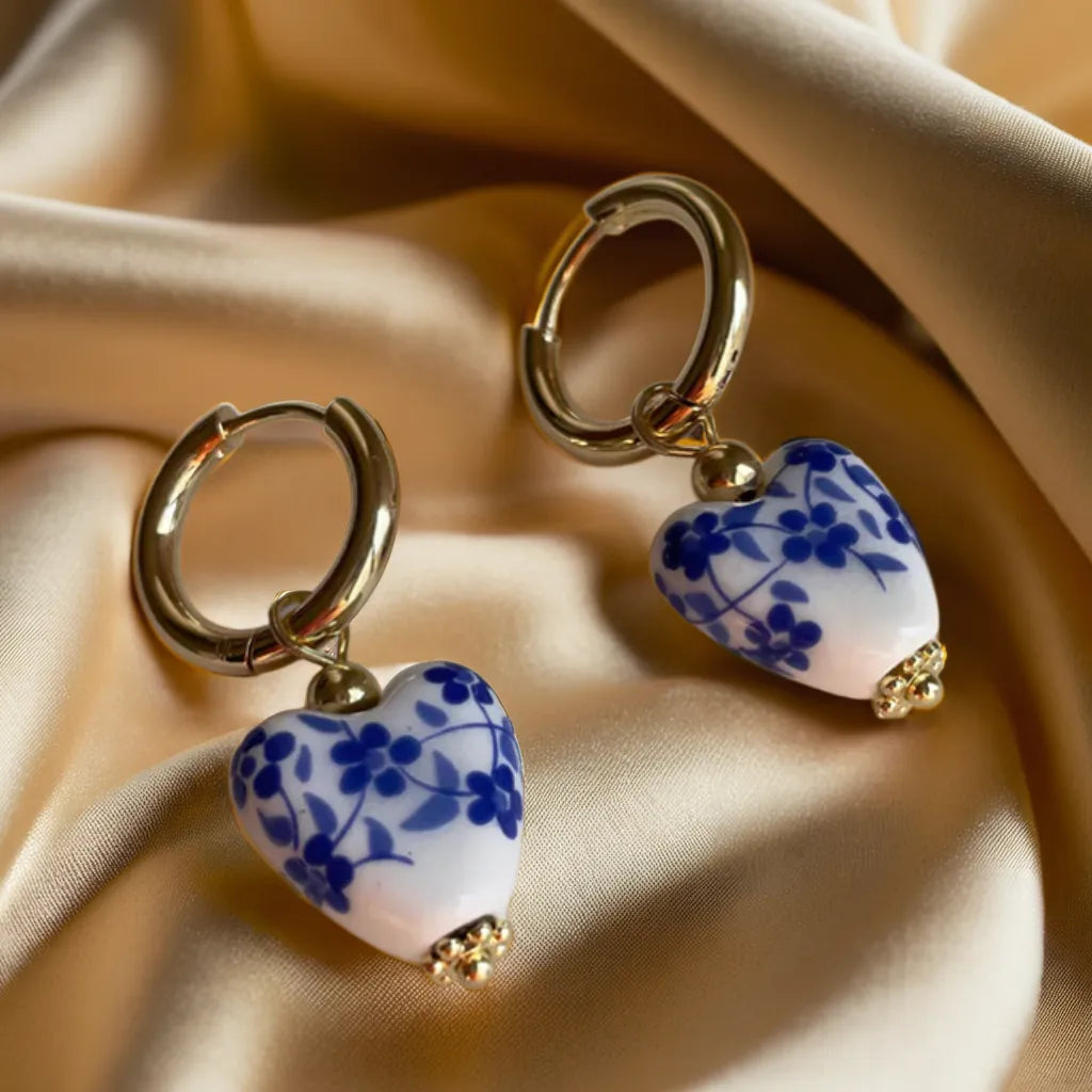 gold earrings women heart Mediterranean huggie hoops

18k gold plated heart earrings close-up

heart tile charm earrings for woman

gold huggie hoop earrings with heart pendant