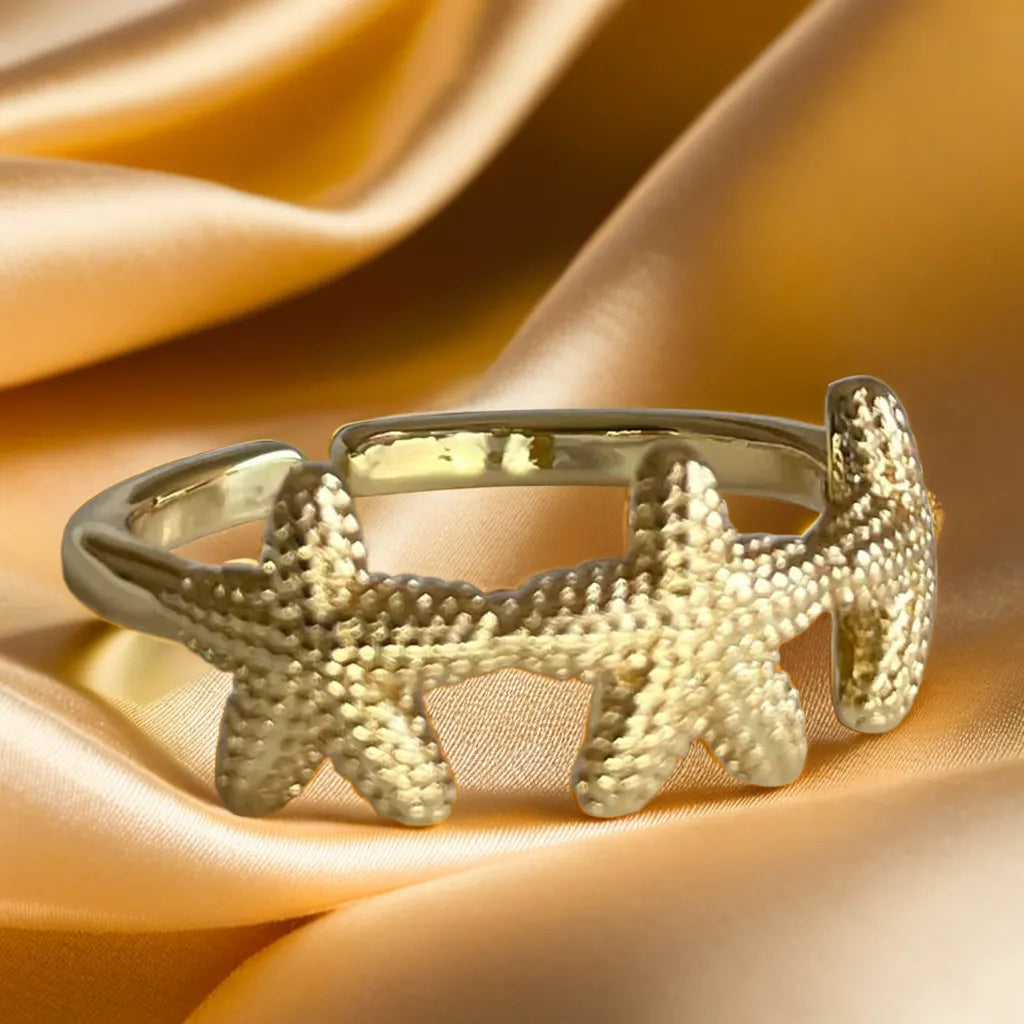 “Ocean Muse Ring – 18k gold plated adjustable women’s starfish ring”
“Gold plated starfish ring for women – Ocean Muse side view”
“Adjustable mini starfish gold ring – Ocean Muse jewelry detail”
“Women’s gold ring inspired by ocean starfish – worn on hand”