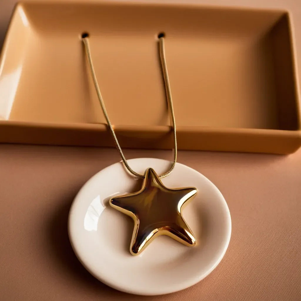 Chunky gold star necklace with bold celestial motif
Celestial necklace styled as a choker for a dramatic look
Gold star choker highlighting the radiant 18k gold plating
Chunky celestial necklace layered with other gold chains