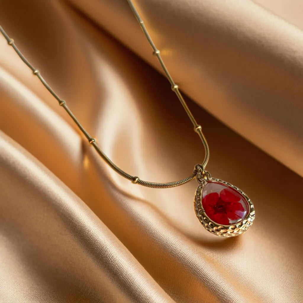 Red pressed flower gold necklace – close-up

18k gold plated women’s necklace – pendant detail

Nature-inspired gold necklace for women – adjustable chain view