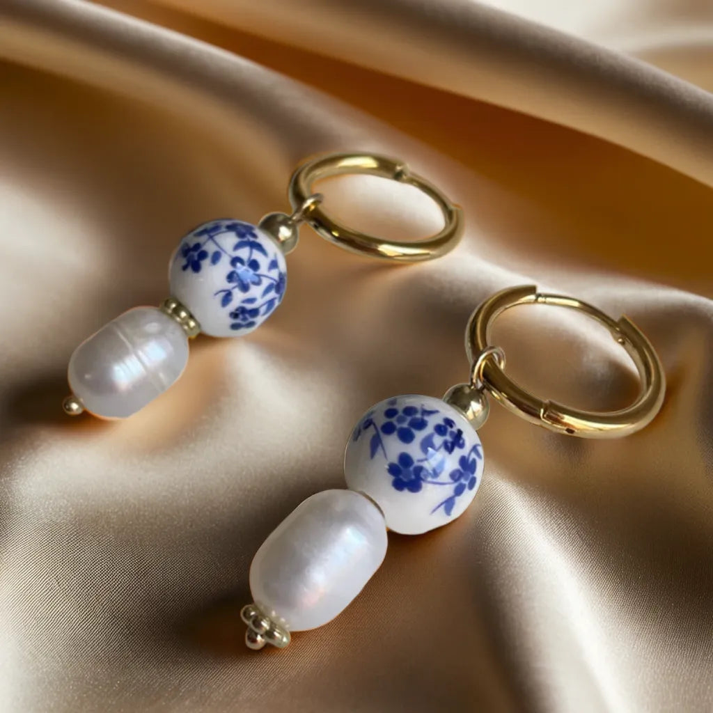 gold earrings women – Mediterranean tile pearl huggie hoops

18k gold plated huggie hoops with pearl charm

Mediterranean style gold earrings close-up

gold earrings for woman – tile design with pearl dangle